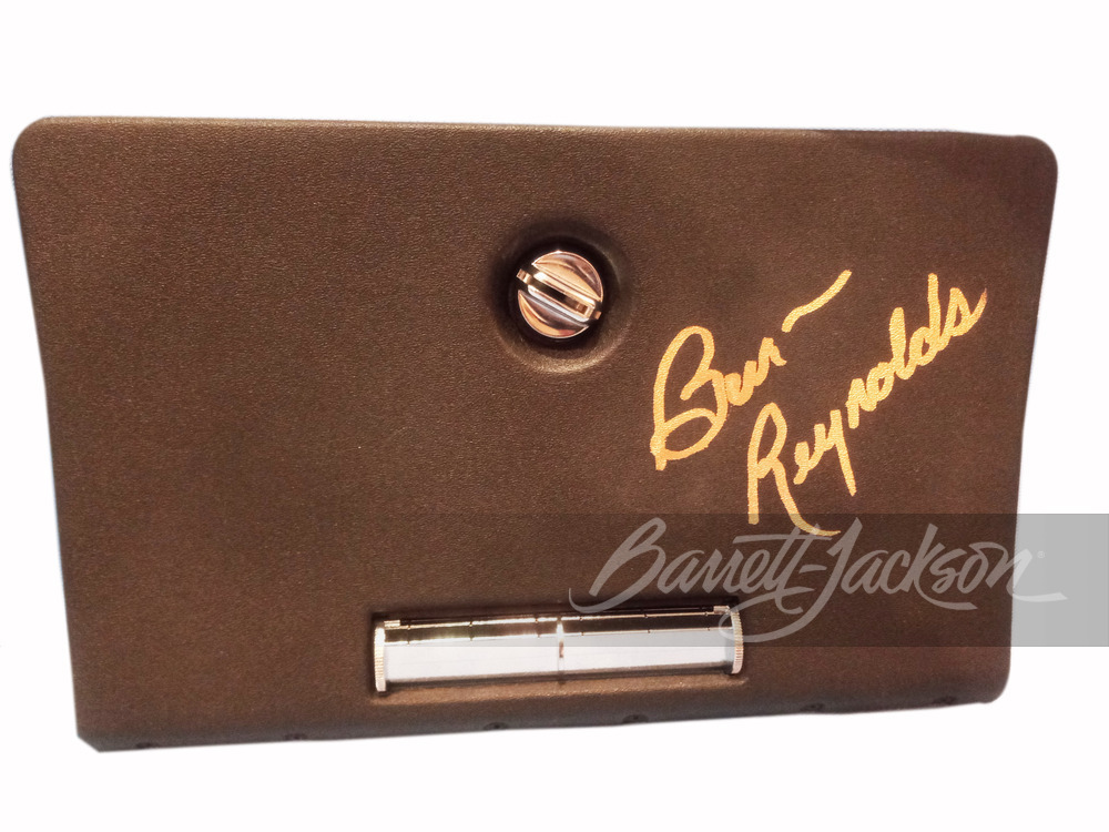 1977 PONTIAC TRANS AM BLACK GLOVEBOX COVER AUTOGRAPHED BY BURT REYNOLDS