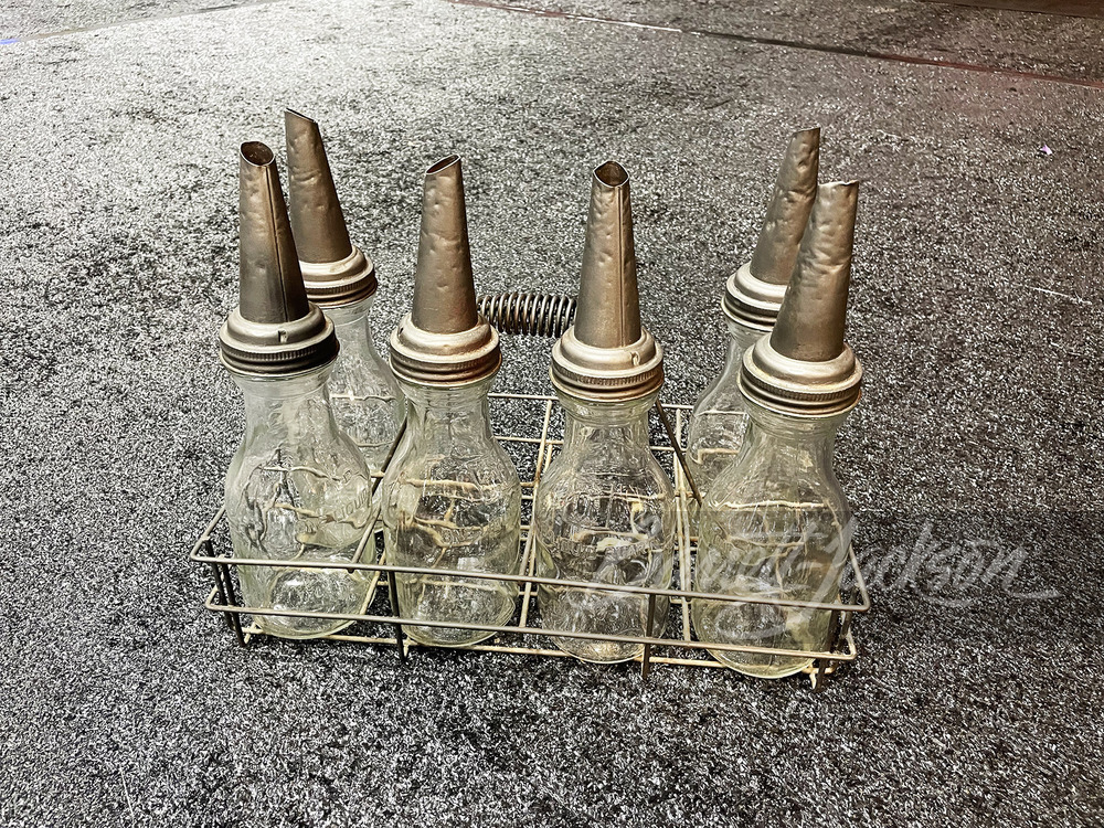 ADDENDUM ITEM - CIRCA 1930S FILLING STATION PORTABLE RACK OF SIX GLASS EMBOSSED OIL BOTTLES.