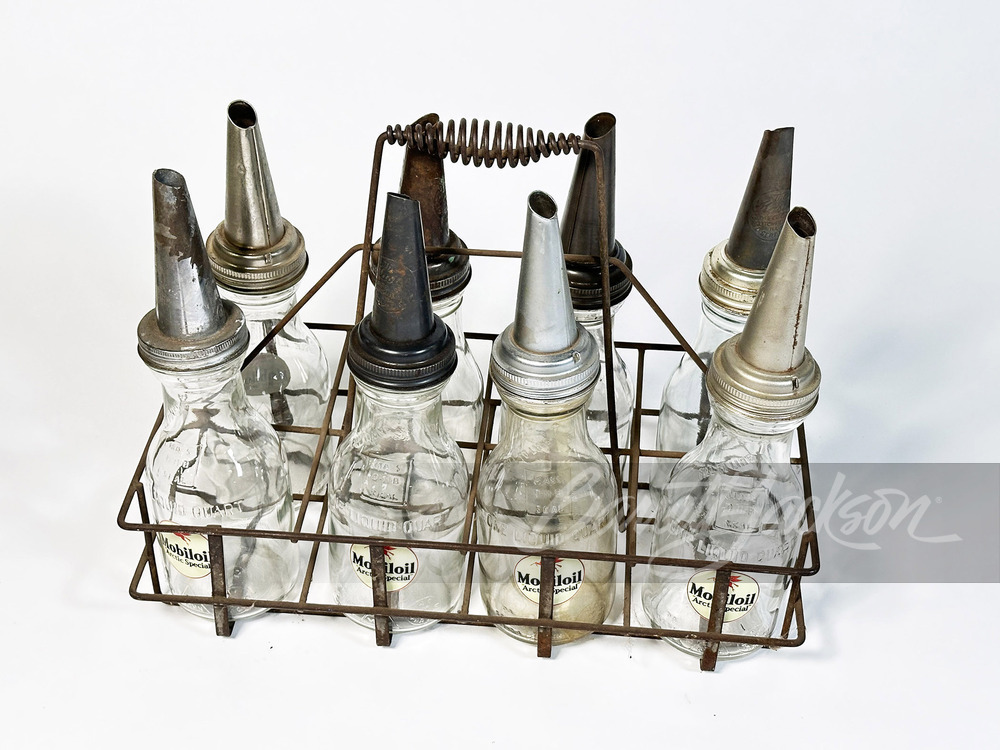 RACK OF EIGHT 1930S GLASS OIL BOTTLES