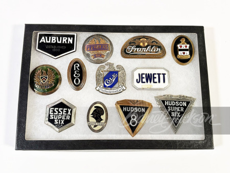 SHADOWBOX OF 12 LATE TEENS-EARLY '20S CAR BADGES